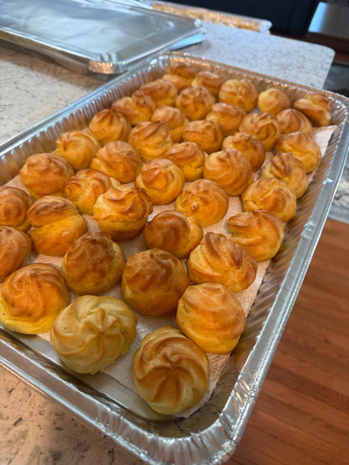 Golden cream puffs arranged in a tray
